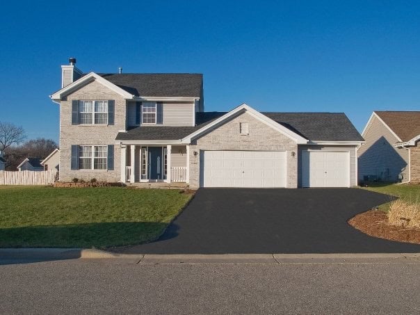 Light colored brick 2-story home with blue shutters